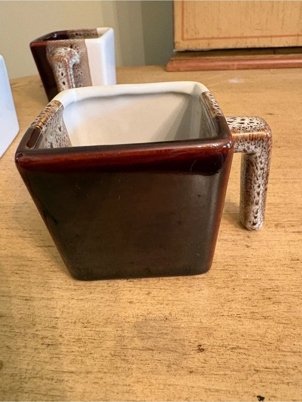 Pier 1 Imports tricolor stoneware square espresso mugs in brown, white, and tan.